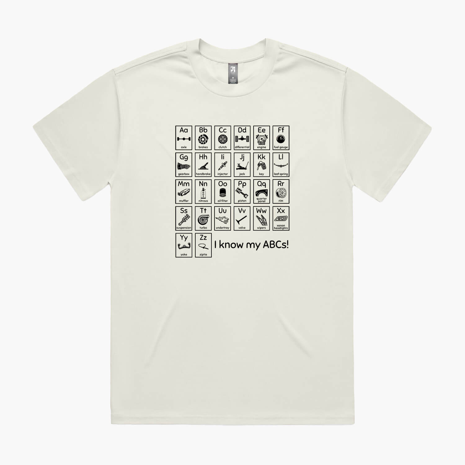 Beige oversized t-shirt with a print of an automotive-themed alphabet chart with car parts for each letter.