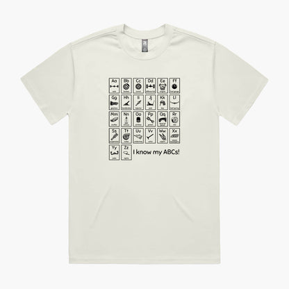 Beige oversized t-shirt with a print of an automotive-themed alphabet chart with car parts for each letter.