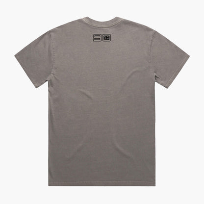 Rear view of a faded grey coloured t-shirt with small 90 neck logo.